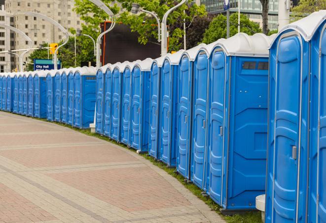 a row of sleek and modern portable restrooms at a special outdoor event in Bluemont